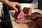 A fillet of beef being sliced