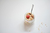 Honey and almond muesli with raspberries in a glass