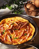 A ham omelette in a pan