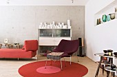 Retro furniture and collection of vases in living room with concrete wall
