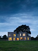 Modern architect-designed house with illuminated windows