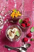Vegan chia chocolate puddings with raspberries, orange and banana