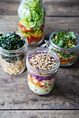 Various layered salads in glass jars