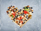 Ingredients for healthy breakfast: muesli in shape of heart
