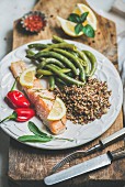 Oven roasted salmon fillet with multicolored quinoa, chilli pepper and poached green beans