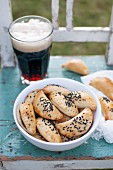 Baked dumplings (pierogi) stuffed with black pudding and topped with black caraway seeds. Served with glass of dark beer