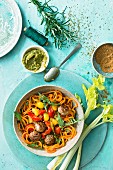 A meatball bowl with spiralized carrot spaghetti, tomatoes and rocket