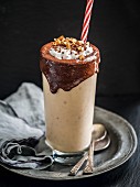 Vegan peanut butter banana smoothie with chocolate topping
