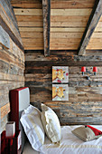 Pictures of cows on wall above bed in rustic bedroom