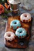 Doughnuts with colourful icing and silver sugar beads