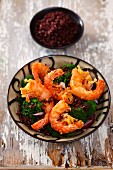 Deep-fried prawns on broccoli and red rice