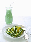 'Schupfnudeln' (finger-shaped potato dumplings) with wild garlic pesto and asparagus, served with a wild garlic and ayran smoothie