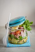 Potato, pesto, egg, tomato and watercress salad in a jar