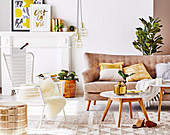 Sofa, coffee table and outdoor chair in the living room with gold-colored accessories