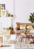 Sofa, coffee table and outdoor chair in the living room with gold-colored accessories