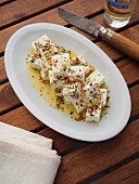Greek feta cheese cut into cubes and seasoned with olive oil and traditional greek spice (Greece)