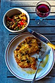 Breaded turkey schnitzel with lemon and caper sauce