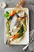 Sea bream in an oven bag with vegetables