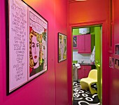 View along hallway with hot-pink walls into kitchen with painted floor