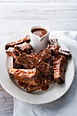 Plate of beef ribs and barbecue sauce