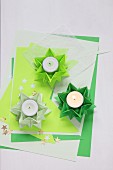 Folded green paper stars used as tealight holders