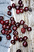 Cherries scattered on a wooden table