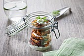 Baked aubergines with tzatziki in a glass jar