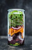 Vegan red beetroot salad with peas in a glass jar