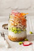 Japanese oriental edamame bean raw lunch jar with fork and lid on the cloth surface