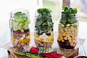Different salads in jars prepared for a brunch in a buffet