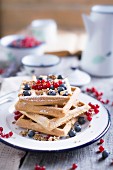 Gluten Free Waffles With Blueberries and Redcurrant on an old wooden table