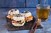 Sushi burgers with carrots, nori leaves, smoked salmon and black sesame