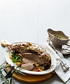 Roast leg of lamb, sliced ​​and served with sauce