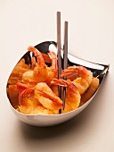 Tempura prawns with chopsticks in small bowls