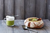 Parsley cappuccino and pea soup served in a hollowed out bread loaf