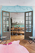 View into kitchen through double lattice doors painted blue and grey