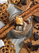 A chocolate vodka drink with marshmallows and pretzels