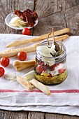 Giant caper salad with tomatoes and Parmesan in a glass jar, with grissini