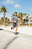 A man in sportswear jogging on the beach