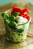Lunch in a glass jar: spaghetti with spinach, mozzarella and basil