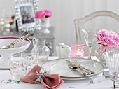 A festive place setting with pink peonies