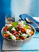 Spinach salad with feta and fried pumpkin