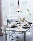 Set table in white dining room