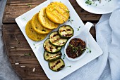 Grilled polenta and courgette slices with sunflower seed and tomato pesto (vegan)