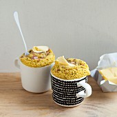 Savoury mug cakes with diced ham and a dab of butter on the top