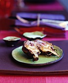 Fried artichoke halves on a green ceramic plate