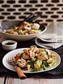Pan-seared scallops on a vegetable salad