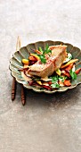 Red snapper poached in coconut stock with brightly coloured wok-fried vegetables