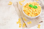 Farfalle pasta in a bowl on wood table