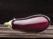 An eggplant on a wooden background